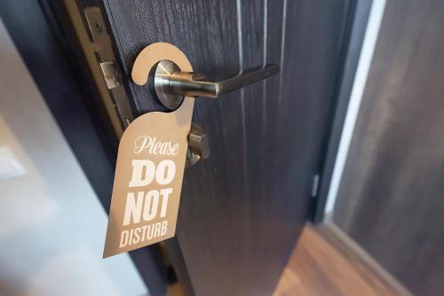 a sign that says do not disturb on a door at Dzvel Ubanshi in Gori