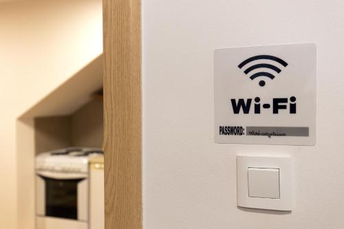 a sign on a door with a wifi sign on it at Bjelašnica Haven Lodge in Bjelašnica