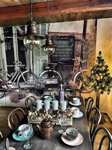 a dining room table with a christmas tree on it at Malinowa Chatka in Jankowice
