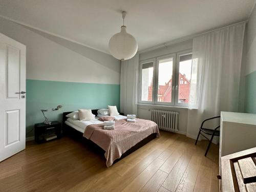 a bedroom with a bed and a lamp in it at Apartament Willow in Gdańsk