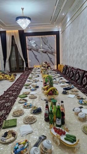 a long table with food and drinks on it at Private villa 