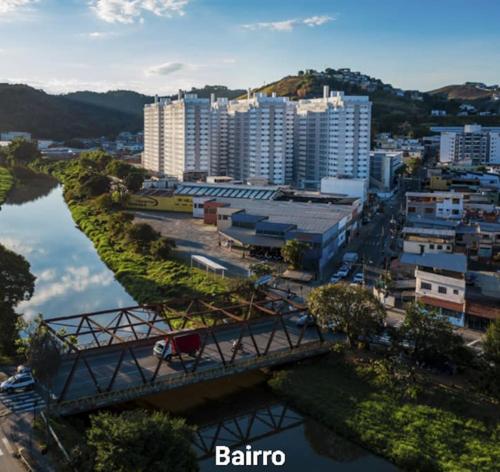 a city with a bridge over a river and buildings at Apartamento 2 quartos completo com garagem in Juiz de Fora