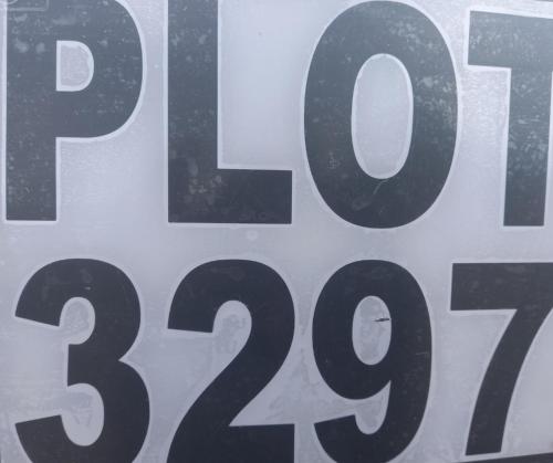 a close up of a sign with the number at Serene Cottage in Francistown