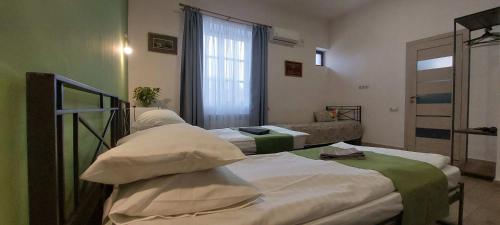 a hospital room with two beds and a couch at Blur Inn Gallery in Yerevan