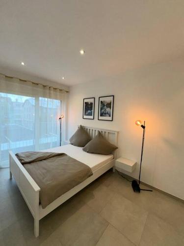 1 dormitorio con cama grande y ventana grande en Comfort Apartment, en Lörrach