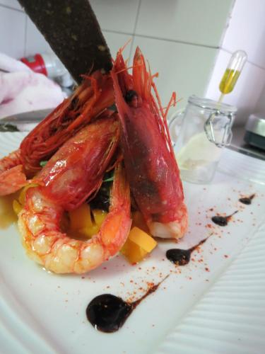 a shrimp on a plate with a knife at Hotel Ristorante Eurossola in Domodossola
