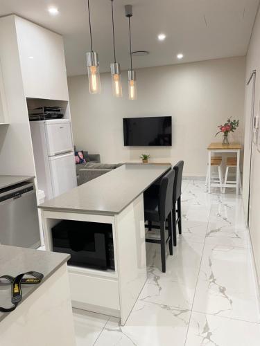 a kitchen with a table and chairs in a room at Guest House - Self Contained in Villawood