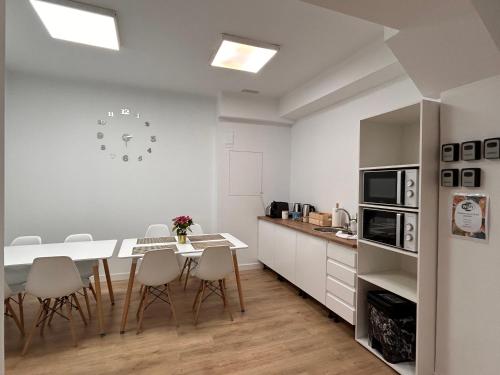 a kitchen with a table and chairs and a counter at Titanic Dreams in Madrid