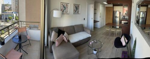 a living room with a couch and a table at Departamento central viña del mar in Viña del Mar