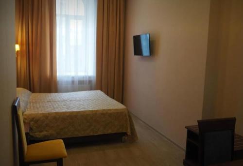 a bedroom with a bed and a television on the wall at VIP apart 770 in Agaraki