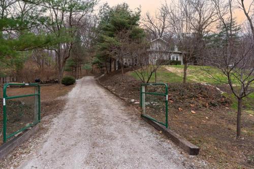 a dirt road with two green gates in a yard at Riverside Retreat! in West Lafayette