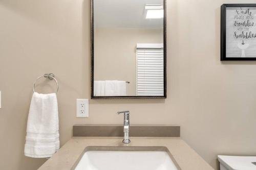 a bathroom with a sink and a mirror at Riverside Retreat! in West Lafayette