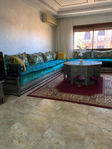 a living room with a blue couch and a table at Lala's apartment in Marrakesh