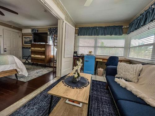 a living room with a blue couch and a table at Vinoy House in St. Petersburg