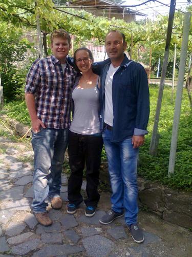 two men and a woman posing for a picture at Giorgi's Homestay in Kutaisi