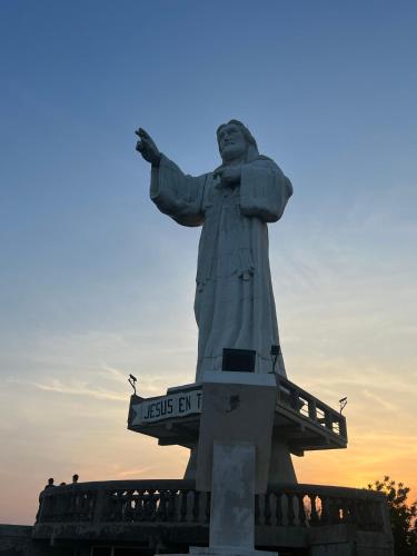 a statue of christ the redeemer at sunset at Buena Onda Backpackers in San Juan del Sur