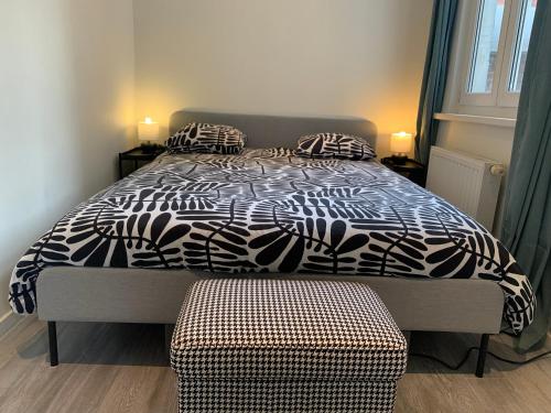 a bedroom with a bed with a black and white comforter at Royal South - Apartment Antwerp with Parkview in Antwerp
