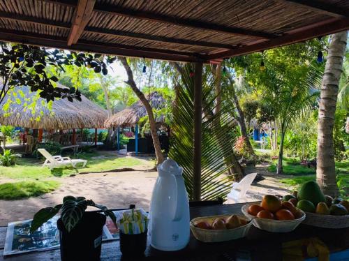 a table with a bowl of fruit and a bottle of milk at Eco Hotel Las Palmeras in Isla Grande