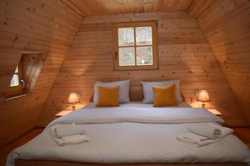 a bedroom with a large bed in a wooden cabin at Vikendica Đoković 2 - Jahorina in Pale