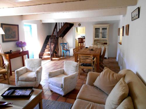 a living room with a couch and chairs and a table at Ty Papy in Bénodet