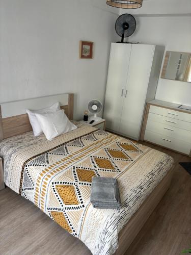 a bedroom with a bed with a purse on it at Cc39 -Q1 in Funchal