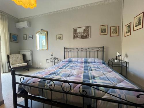 a bedroom with a bed and a chair at Il Giardino Nascosto B&B in Vasto