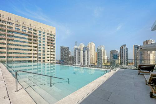 a large swimming pool on the roof of a building at Modern 2BR High Floor Haven in Vida Dubai Marina in Dubai
