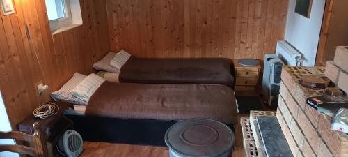 Kleines Zimmer mit 2 Betten und einem Tisch in der Unterkunft KopanikTreskaPotok15e in Kopaonik