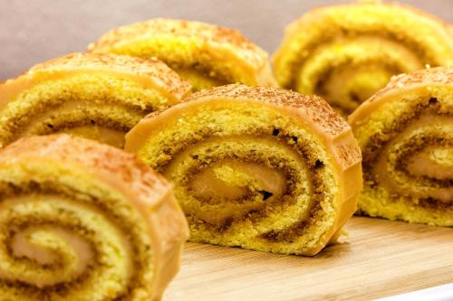 a group of cinnamon rolls sitting on a cutting board at Locanda Del Feudo Suite & Restaurant in Castelvetro di Modena