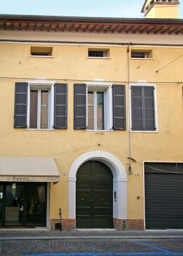 a yellow building with black doors and windows at A Casa Di Paola Suite in Ravenna