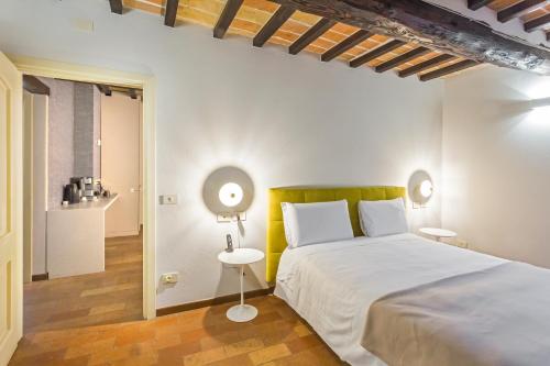 a bedroom with a large white bed and a table at Locanda Del Feudo Suite & Restaurant in Castelvetro di Modena