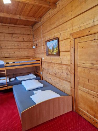 a room with three bunk beds in a log cabin at Bukovina Concept obok stoku i basenów termalnych in Bukowina Tatrzańska