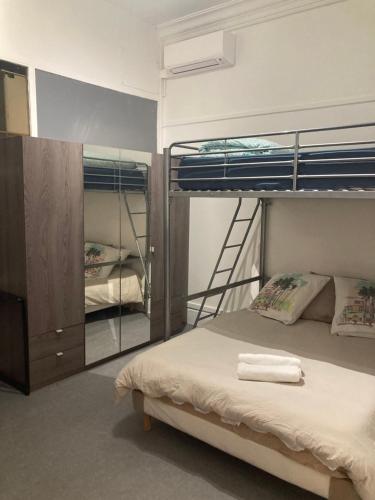 a bedroom with two bunk beds and a mirror at AV. CHAMPS ELYSEES 78 in Paris