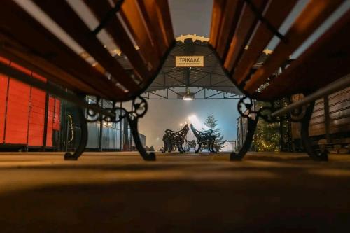 a bench with a view of a horse drawn carriage at Andromache's Cozy Villa close to Meteora-Trikala in Tríkala