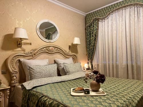 a bedroom with a bed with a tray of food on it at Luxury Flat close to the Border in Narva