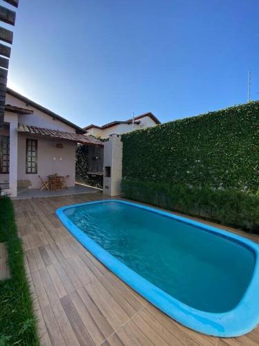 a blue swimming pool in front of a house at Casa da Cascata de Crato in Crato