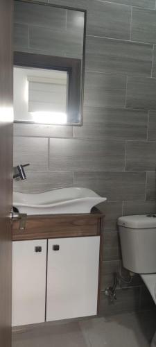 a bathroom with a sink and a mirror at Hotel Mykonos Manta in Manta