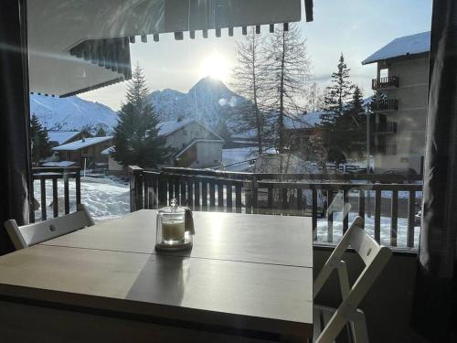 a glass candle sitting on a table on a balcony at *Nouveau* Studio au pied du télésiège du Diable in Les Deux Alpes