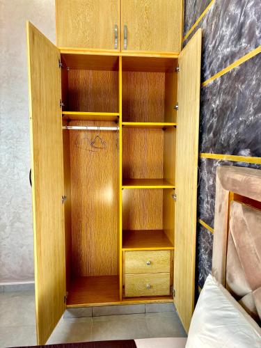 a wooden closet with wooden shelves in a room at Villa Berkane avec Piscine Jacuzzi privée Sans vis-à-vis in Berkawe
