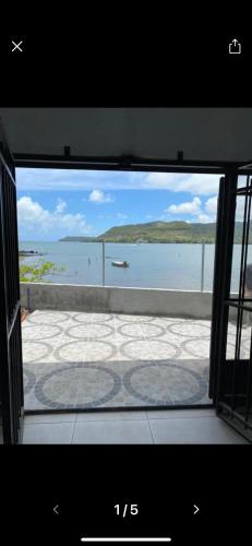 a view of the ocean from a window at Ashan Luxury Seafront Villa 2 in Grande Rivière Sud Est