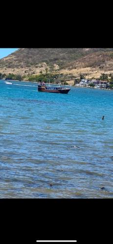 a boat in the middle of a large body of water at Ashan Luxury Seafront Villa 2 in Grande Rivière Sud Est