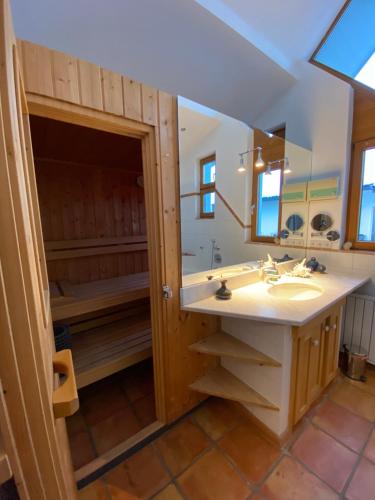 a bathroom with a sink and a bath tub at Ferienhaus in Westendorf in Westendorf