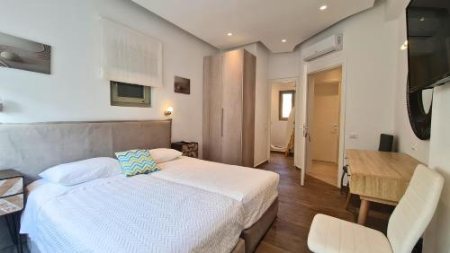 a bedroom with a bed and a table and a desk at VILLA PANAMERA Mykonos, Private Heaven, Supreme View! in Fanari