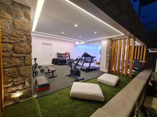 a gym with treadmills and exercise equipment in a house at VILLA PANAMERA Mykonos, Private Heaven, Supreme View! in Fanari