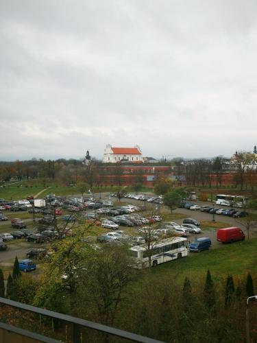 a parking lot with a lot of buses and cars at Czwarte Piętro in Zamość