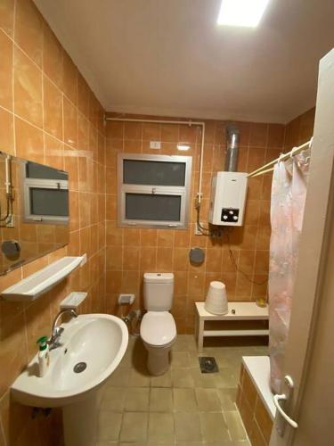 a bathroom with a white toilet and a sink at Lovely 3 Bedrooms Apartment in Madinaty