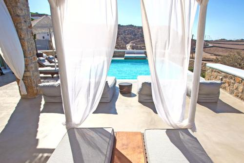 a view of a pool from under a tent at VILLA PANAMERA Mykonos, Private Heaven, Supreme View! in Fanari