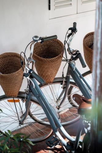 two bikes with baskets are parked in a room at Chic stay HANA Boutique hotel in Luang Prabang
