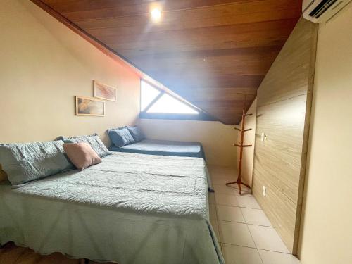 a small bedroom with a bed in a attic at Flat Condomínio Monte Castelo Gravatá in Bezerros
