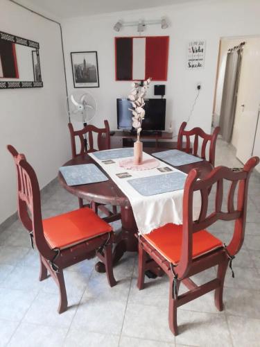 a dining room with a table and four chairs at La estadía in La Banda